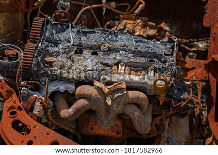 Rusting hulk wreck of a car engine left abandoned in the bush with many of its parts missing Royalty-Free Stock Photo #1817582966