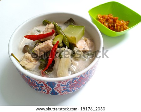 Vegetable lodeh or vegetable with coconut milk soup is a traditional Indonesian culinary food in a white bowl served. Vegetables are long beans, cabbage, red chili, green chili, eggplant, and more 
