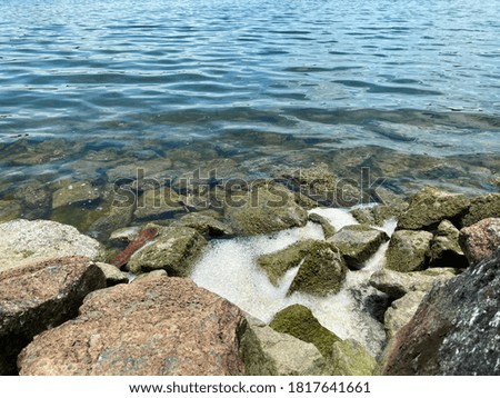 Water bubbles on rocky shoreline