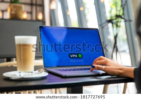 Person connecting her laptop to a VPN service. Royalty-Free Stock Photo #1817727695