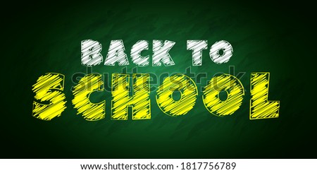 "Back to school" lettering in chalk style on a green chalkboard