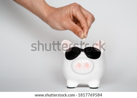  investing in a financial airbag for a future good life. hand holding a piggy bank white background coins