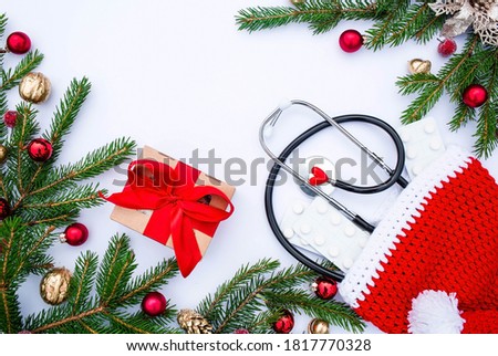 Medical banner 2021 for clinics with pills,gift, stethoscope and Christmas tree on a white background. Copyspace. Medicine new year flatlay.