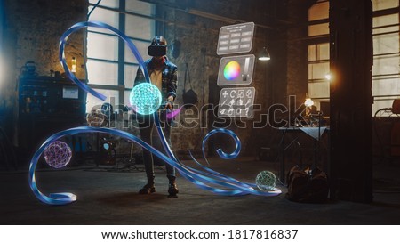 Talented Female Artist Wearing Augmented Reality Headset Working on Abstract 3D Sculpture with Controllers, Uses Gestures To Create Multimedia Internet Concept Art. 3D Animation Special Effect Royalty-Free Stock Photo #1817816837