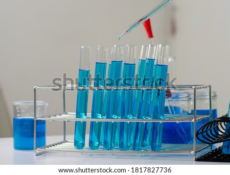 Pipette dropping a sample into a test tube and science experiments ,Laboratory glassware containing chemical liquid, 