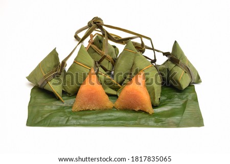 Steamed sticky rice wrapped in bamboo leaves on white background