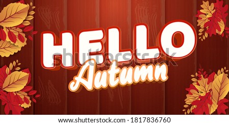 Hello autumn stylish text and fall leaves on wooden background
