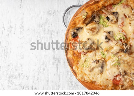 Vegetarian pizza with mushrooms on wholegrain flour dough near the copy space close-up view from above.
