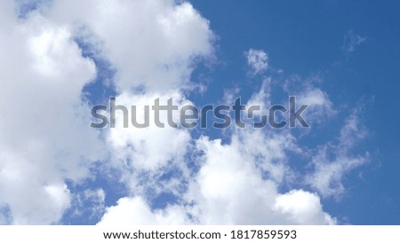 white big clouds against blue background