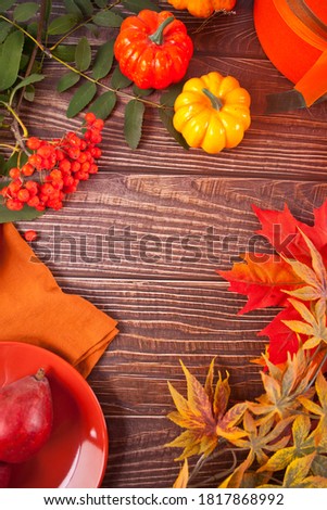 Composition with pumpkin, autumn leaves and red pears. Cozy autumn mood concept. Top view. Copy space.