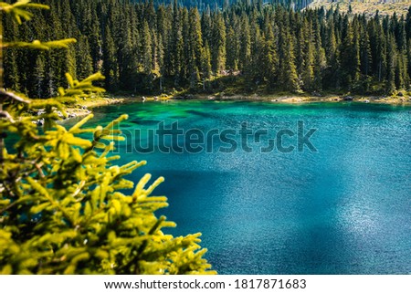 Landscape of Lake Carezza or Karersee and Dolomites in background
