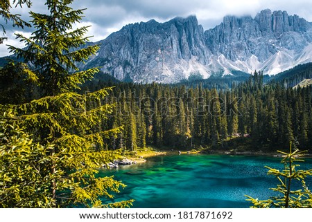 Landscape of Lake Carezza or Karersee and Dolomites in background