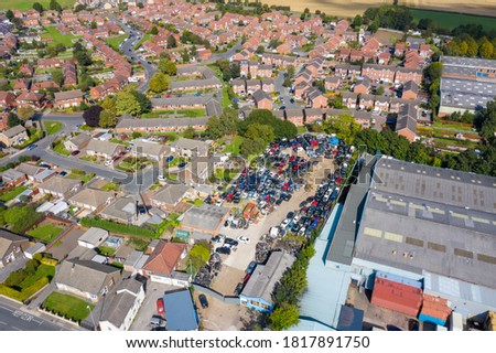 Aerial photo of the British town of Ossett, a market town of the City of Wakefield, West Yorkshire, England showing a typical UK housing estate and  scrap yard