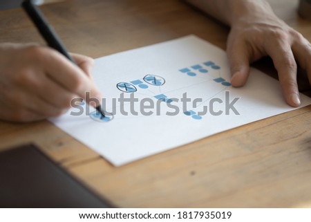 Close up of CEO or boss sit at desk brainstorm work on company business project. Male HR or recruiter consider analyze corporate team or group hierarchy at workplace. Human resources concept.
