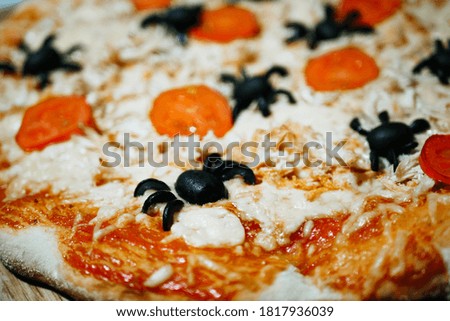 Halloween party treats. Spooky pizza. Spiders made of olives. Decorated fast food
