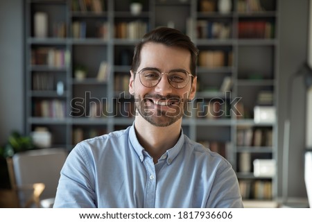 Profile picture of happy young Caucasian man in spectacles show confidence and leadership. Headshot portrait of smiling millennial male in glasses posing indoors at home. Employment, success concept.