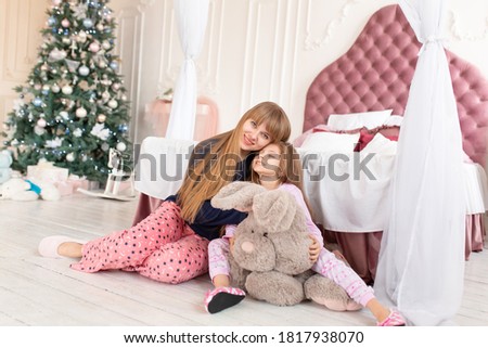 The little girl doesn't want to go to bed on Christmas night. Christmas tale. Happy childhood.