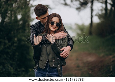 Young beautiful couple in the woods together