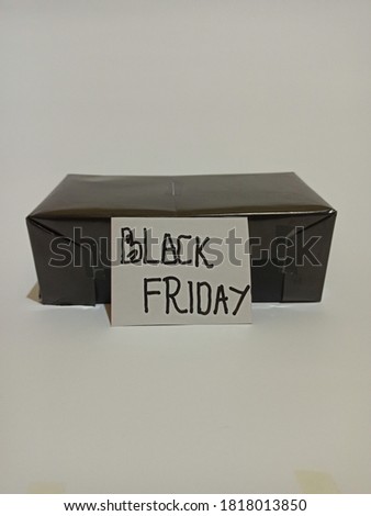 Black Friday tag with gift box and colorful ornaments on white background. Black Friday words with abstract decoration for promotion or advertisement