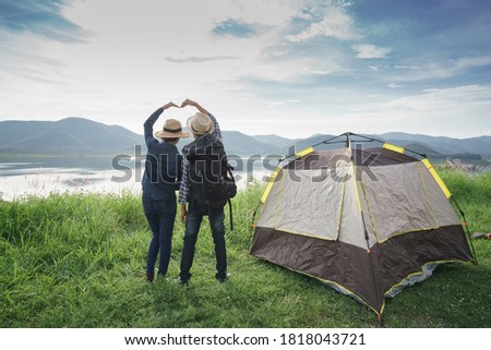 Loving couple travel relax camping in the autumn holiday.