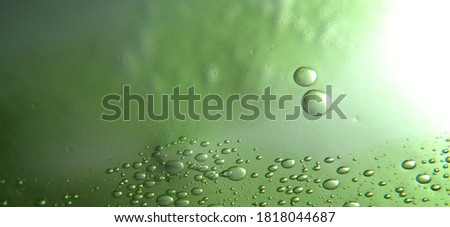 Green bubbles in glass (selective focus)