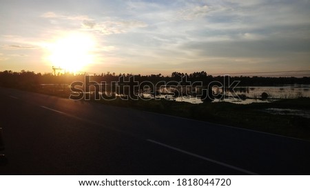 The pictures show a beautiful twilight falling on a highway. The colorful glow of the setting sun seems to have colored nature. The highway is also obsessed with a strange illusion
