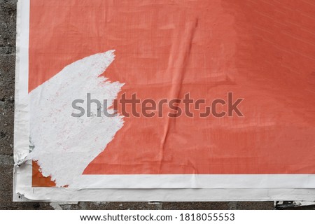 Red vintage torn street poster paper texture on exposed brick wall background