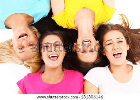 A picture of a joyful group of friends lying over white background