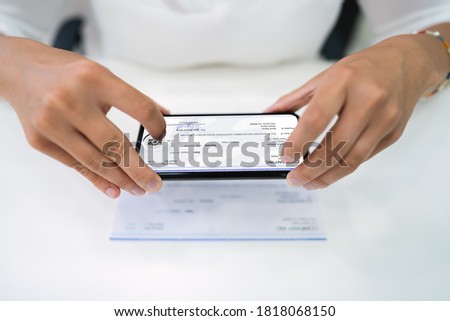 Remote Check Deposit Using Phone. Taking Document Photo Royalty-Free Stock Photo #1818068150