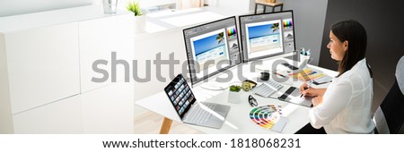 Graphic Designer Artist Working On Multiple Computer Screens Royalty-Free Stock Photo #1818068231