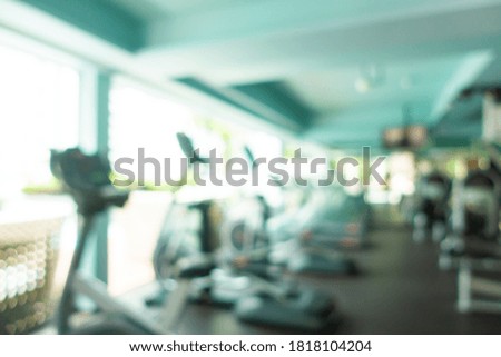 Abstract blur fitness equipment in gym room interior for background