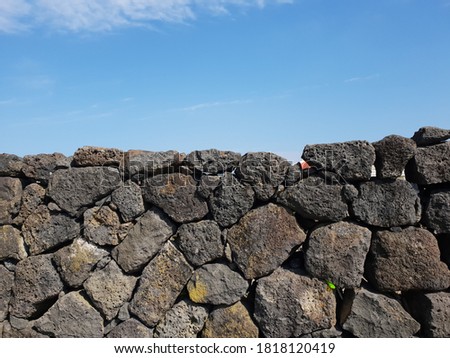 Old stone wall in Jeju island. 
There used to be strong winds in Jeju Island. So people there started to build fence using rocks. It has holes to prevent a fall from the wind.