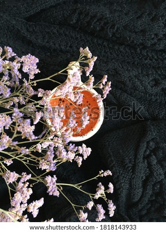 orange cup on a background of flowers