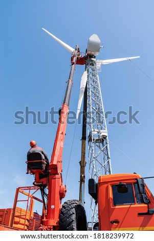 Worker operator of the aerial platform at the workplace. Installation of a wind generator. Russia, Orenburg region Royalty-Free Stock Photo #1818239972