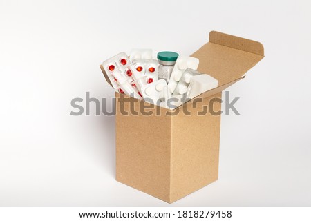Delivery of medicines home from pharmacy. Cardboard box with medicines isolated on white Royalty-Free Stock Photo #1818279458