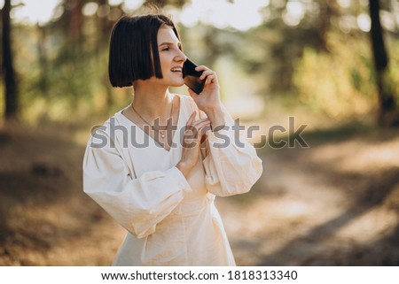 Young woman talking on the phone in park