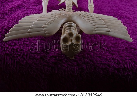 Spooky Angel of Death close up  on fluffy purple background. Concept for Halloween poster.