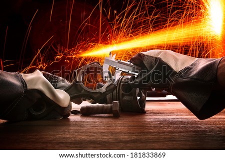 hand of worker man working by leather hand glove protection heat of splashing fire in heavy industry factory use for metal and iron industrial manufacturing theme