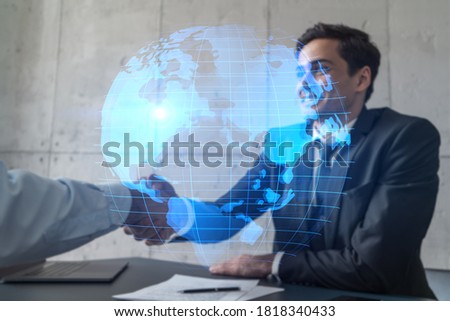 Two businessman shaking hands and world map hologram. Double exposure. Handshake.