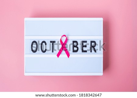 Breast Cancer Awareness month, Pink Ribbon on lightbox with OCTOBER text background for supporting people living and illness. International Women, Mother and World cancer day concept