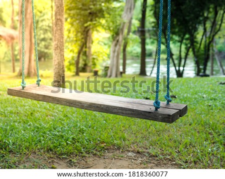The picture of Old wooden vintage  Swing & Hang Chair on garden background.golden evening sunlight.