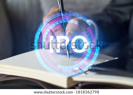 Businessman in suit taking notes. Multiexposure with ipo symbol hologram. Man writing down important information in his business diary. Investment concept.