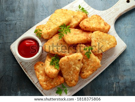 Hash brown potato with ketchup on white wooden board Royalty-Free Stock Photo #1818375806