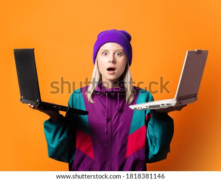 Style woman in 90s tracksuit with two notebooks on orange background