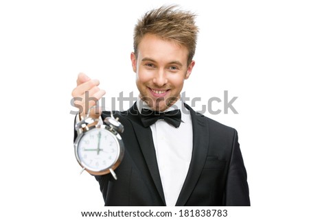 Half-length portrait of businessman holding alarm clock, isolated on white