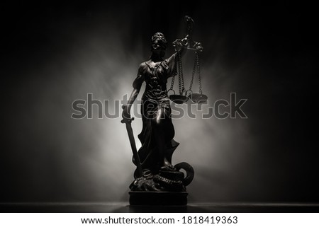 Law concept. Miniature colorful artwork decoration with fog and backlight. The Statue of Justice - lady justice or Iustitia / Justitia the Roman goddess of Justice. Selective focus Royalty-Free Stock Photo #1818419363