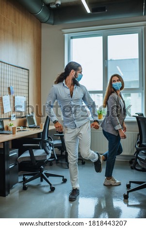 Informal greeting foot bump by business people in the office during outbreak of the global pandemic COVID-19. Avoiding handshakes in a new normal. Royalty-Free Stock Photo #1818443207