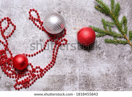 green branch with Christmas decorations, Christmas composition on a concrete background. Flat lay, top view, copy space.