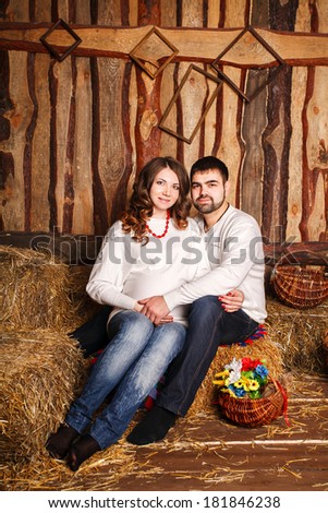 Cheerful young couple expecting a baby. Beautiful spring interior