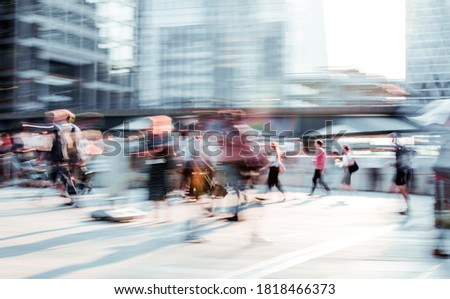 Beautiful background with motion blur people. People walking in the  City of London in early morning. People rushing to work. London, UK
